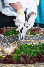 The cook cuts the sturgeon