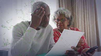 Couple furrowing brow and raising concern over finance document, tapping phone with animated data