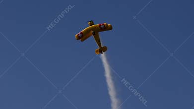 Bucker Bu 133 Jungmeister RC model performs a stall turn with smoke