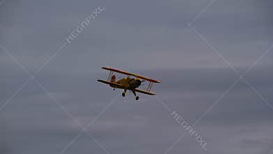 Bucker Bu 133 Jungmeister RC model in a banking turn against the sky