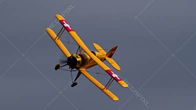 Close-up of a Bucker Bu 133 biplane in a slow banking turn