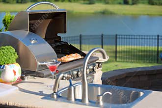 Cooking Cedar Salmon on the Barbecue at the Outdoor Kitchen