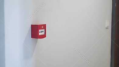 Red fire alarm button on wall ,