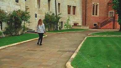 happy woman tourist walks against background buildings city Krakow Poland