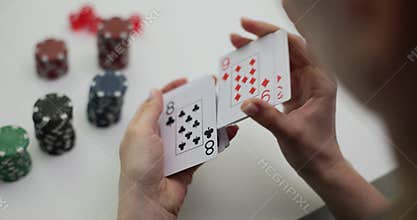 Female croupier shuffles deck of playing cards in casino