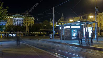 New modern trams of Croatian capital Zagreb night timelapse near railway station. CROATIA