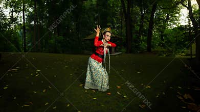 a Balinese dancer wearing a red costume which becomes a visual attraction for the audience with the beauty of the dance performed