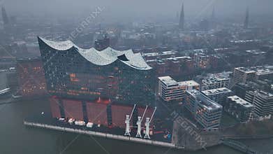 4K aerial drone view of HafenCity and the Philharmonic on a snowy evening, Hamburg, Hanseatic City.