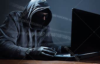 Hacker stealing data from a laptop
