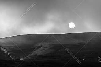 The winter sun hangs over the hills