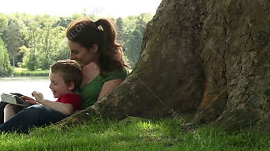 Mum and son playing under a tree