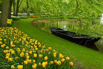 Spring garden with canal and boat