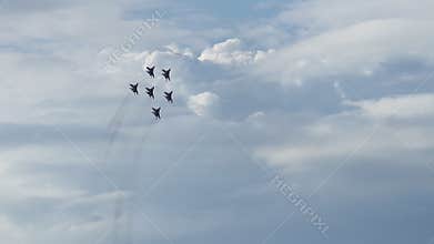 Military jets performing aerobatics in cloudy sky