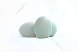Three blue-green duck eggs on a white background.