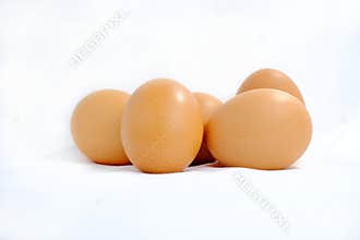 Group of brown eggs on a white background.