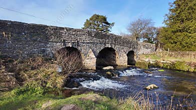 East river dart fast flowing under a bridge Dartmoor Devon UK