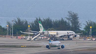 Airplanes on the airfield, sea in the background