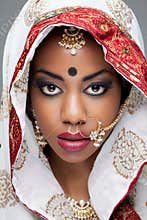 Young Indian woman in traditional clothing with bridal makeup and jewelry