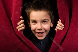 Child appearing beneath the curtain