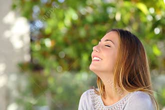 Young happy smiling woman doing deep breath exercises