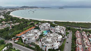 Coastal aerial view showcasing beachfront resorts and vibrant town life