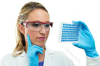 Young researcher examining a microplate