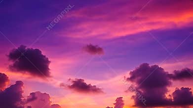 A twilight canvas: clouds ablaze in shades of purple, pink, and orange at the brink of dusk