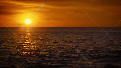 Sun over tropical ocean. Beautiful orange sunset