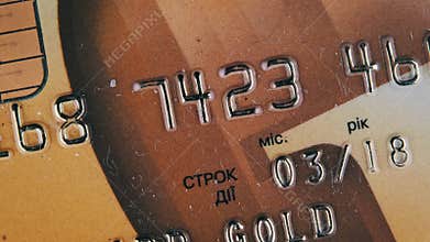 Golden Debit Card Rotates Close-Up