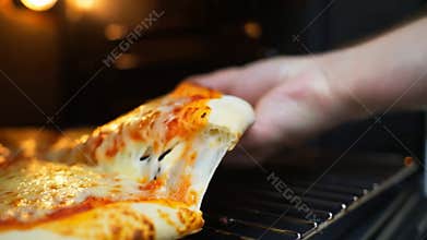 Hand lifting slice cheesy pizza gooey mozzarella pull grill oven background stock footage Generative AI