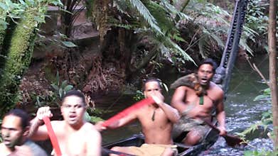 Maori men floating in a canoe