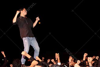 Singer on stage, crowd, hands
