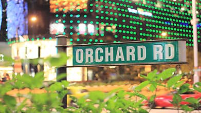 Orchard Road Sign with Traffic Time Lapse in Business District