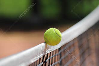 Tennis ball over net falls in the opponent's field