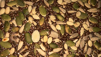 Mixed seeds background with pumpkin seeds sunflower kernels and flax seeds close up
