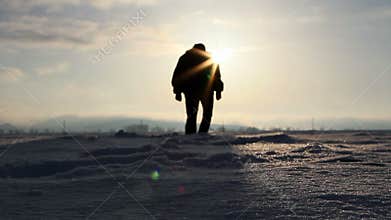 Silhouette walking in deep snow