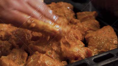 Marinated chicken cooking on griddle with curry sauce pot