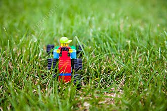 The toy lego tractor with lego driver