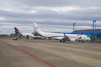 Latam Airlines Airbus A321 and Amelia Embraer E190LR in Silversea Expeditions livery at the terminal gates in Punta Arenas airport