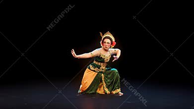 Traditional Javanese Dancer in Strong Defensive Pose on Stage