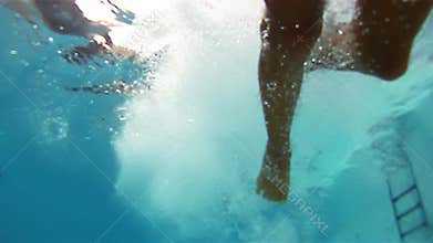 Boy jumping into the pool