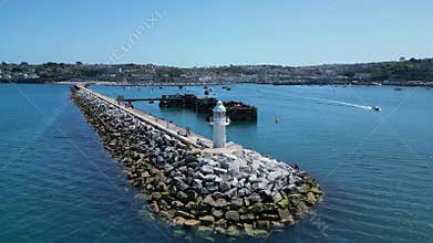 Brixham, Torbay, South Devon, England: DRONE VIEWS: Brixham Harbour lighthouse, the Outer Harbour Wall and various boats