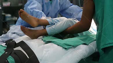 Nurses moving from hospital bed in operation room to stretcher gurney bed to the recovery area