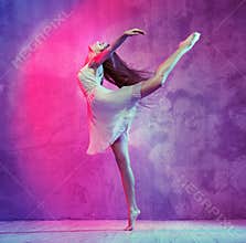 Flexible young ballet dancer on the dance floor