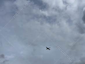 Commercial Airplane Flying Over Amsterdam Forest Under Cloudy Sky Netherlands