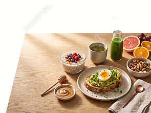 A wholesome morning breakfast spread features avocado sourdough toast topped with a soft boiled egg for a nutritious meal
