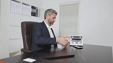 Businessman at office desk with money counting machine. Banker money counting in office. Financial control. Money operation in