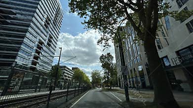 Low-angle view of modern office towers and tram lines above city