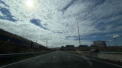 A neutral view from inside a car dashboard, showcasing a concrete tunnel