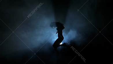 Dancing silhouettes of woman in a nightclub. Slow